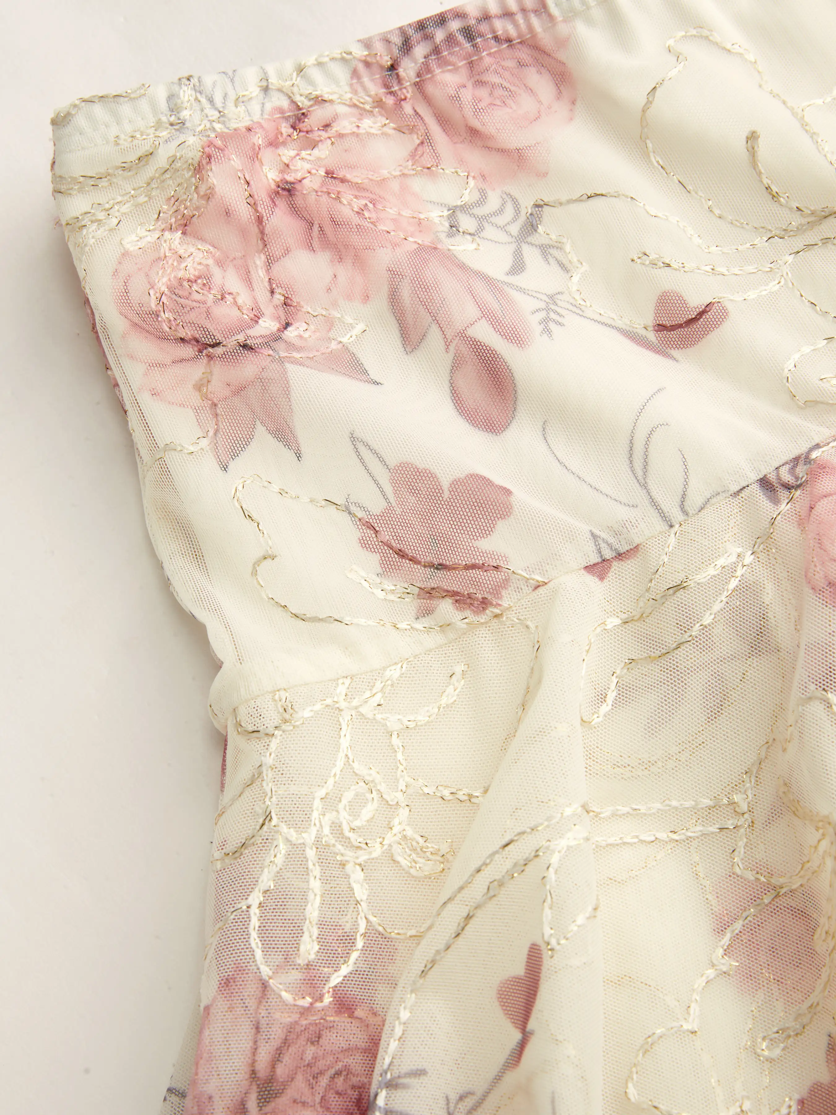 10045-mesh-mid-rise-floral-asymmetrical-ruffle-hem-mini-skirt-1.webp