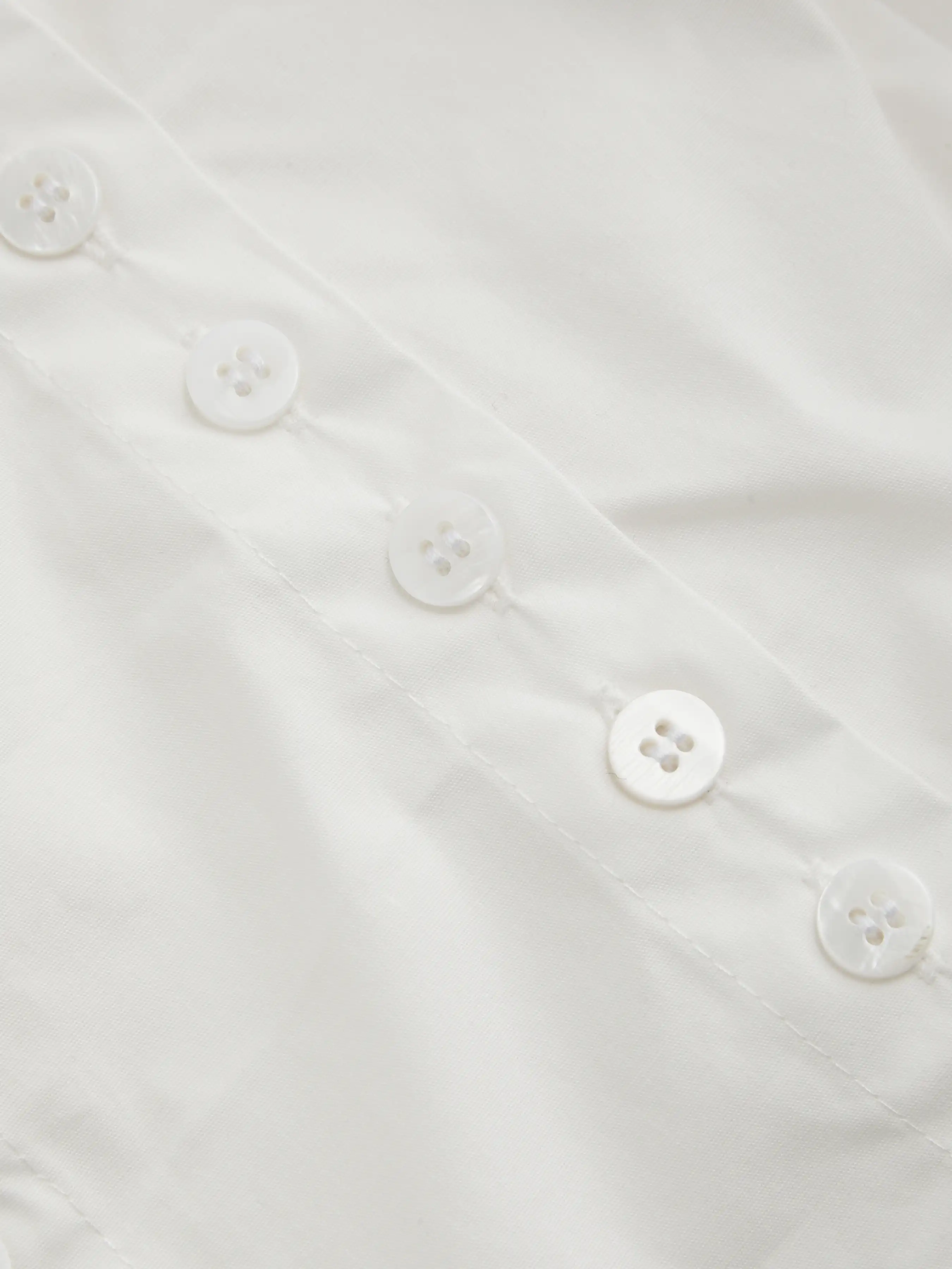 5045-100-cotton-asymmetrical-neck-button-curved-hem-short-sleeve-blouse-1.jpg