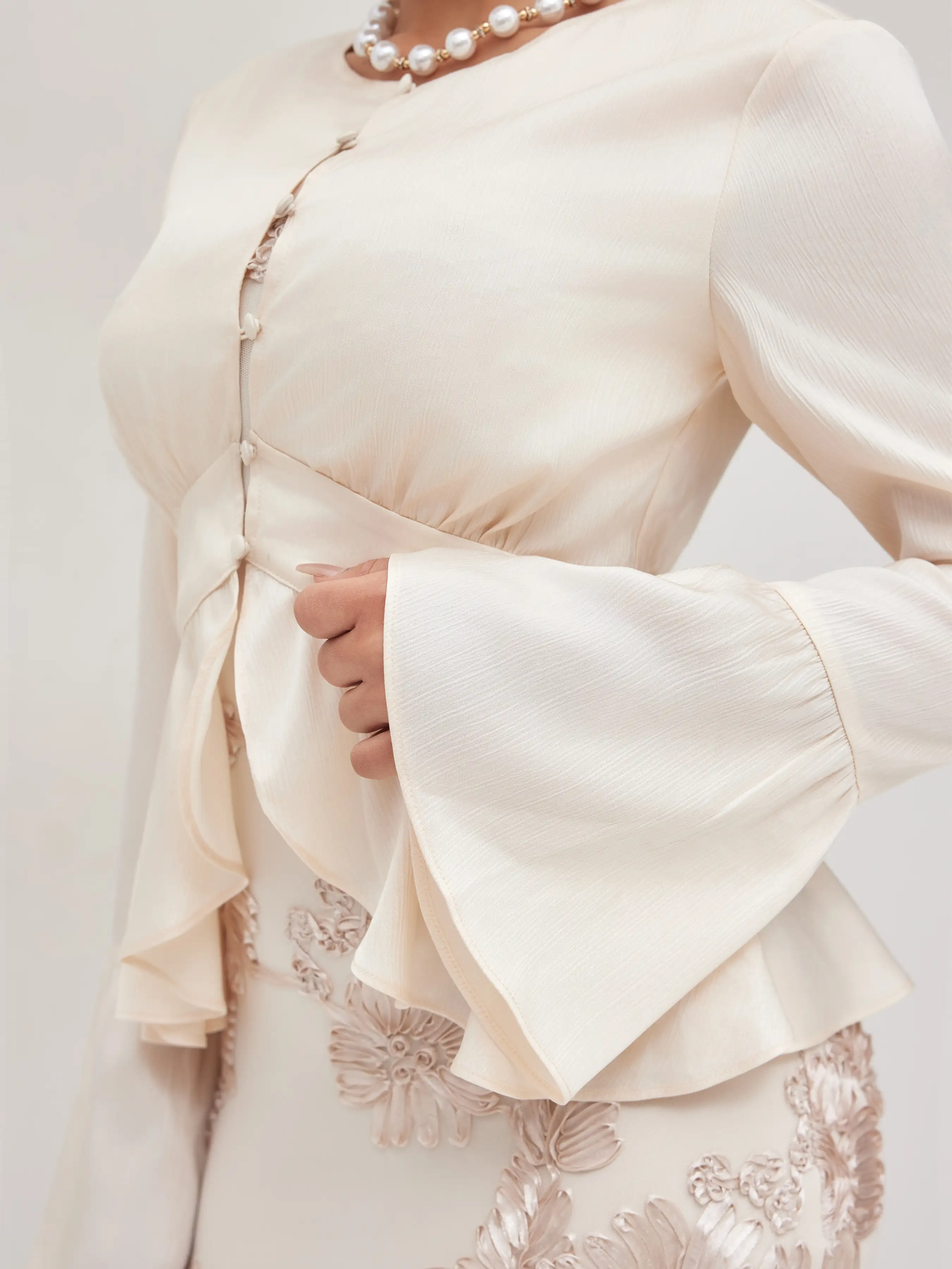 6179-round-neckline-ruffle-hem-blouse-1.webp