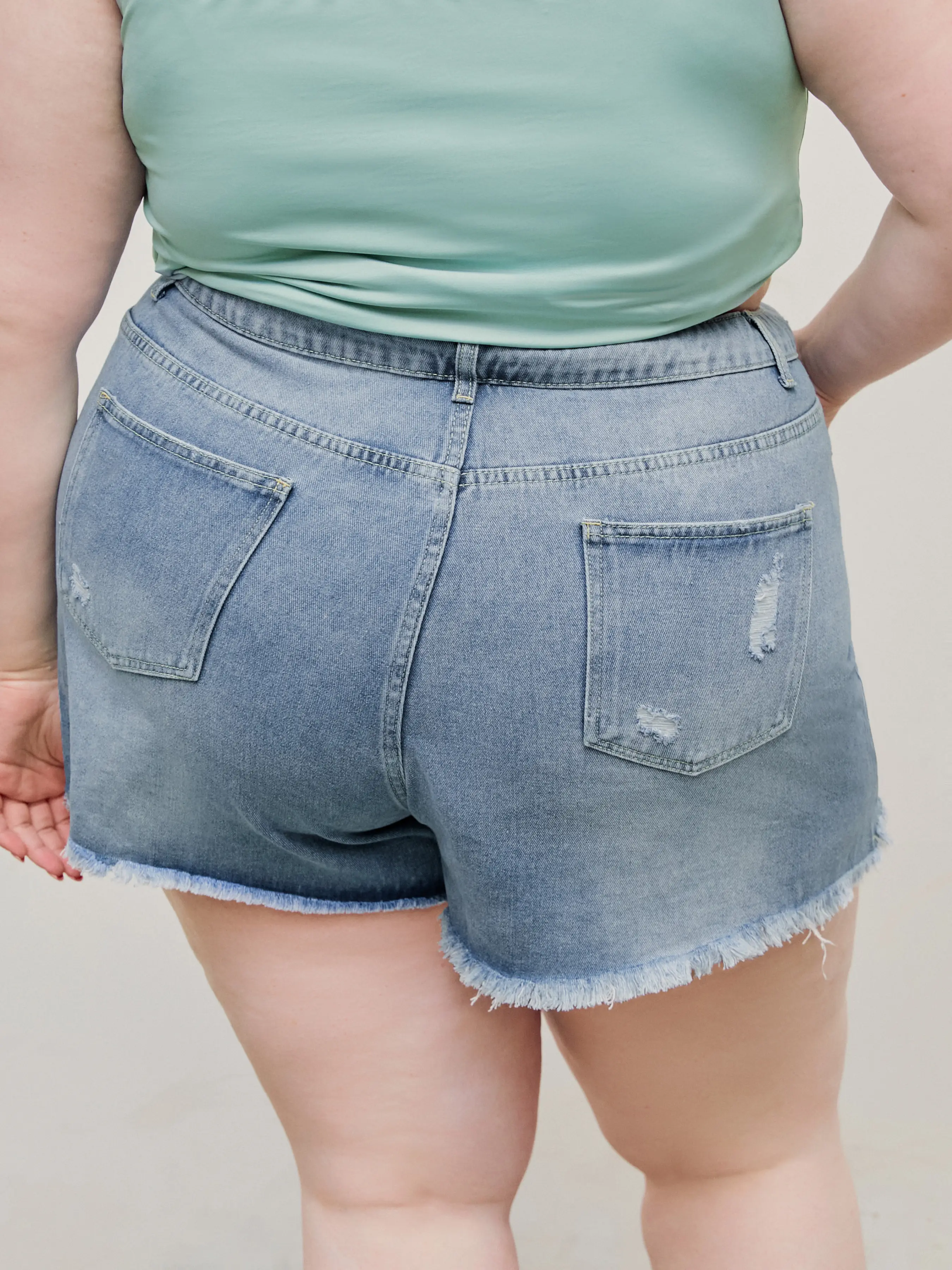 7493-tassels-ripped-pocket-jean-shorts-curve-plus-1.webp